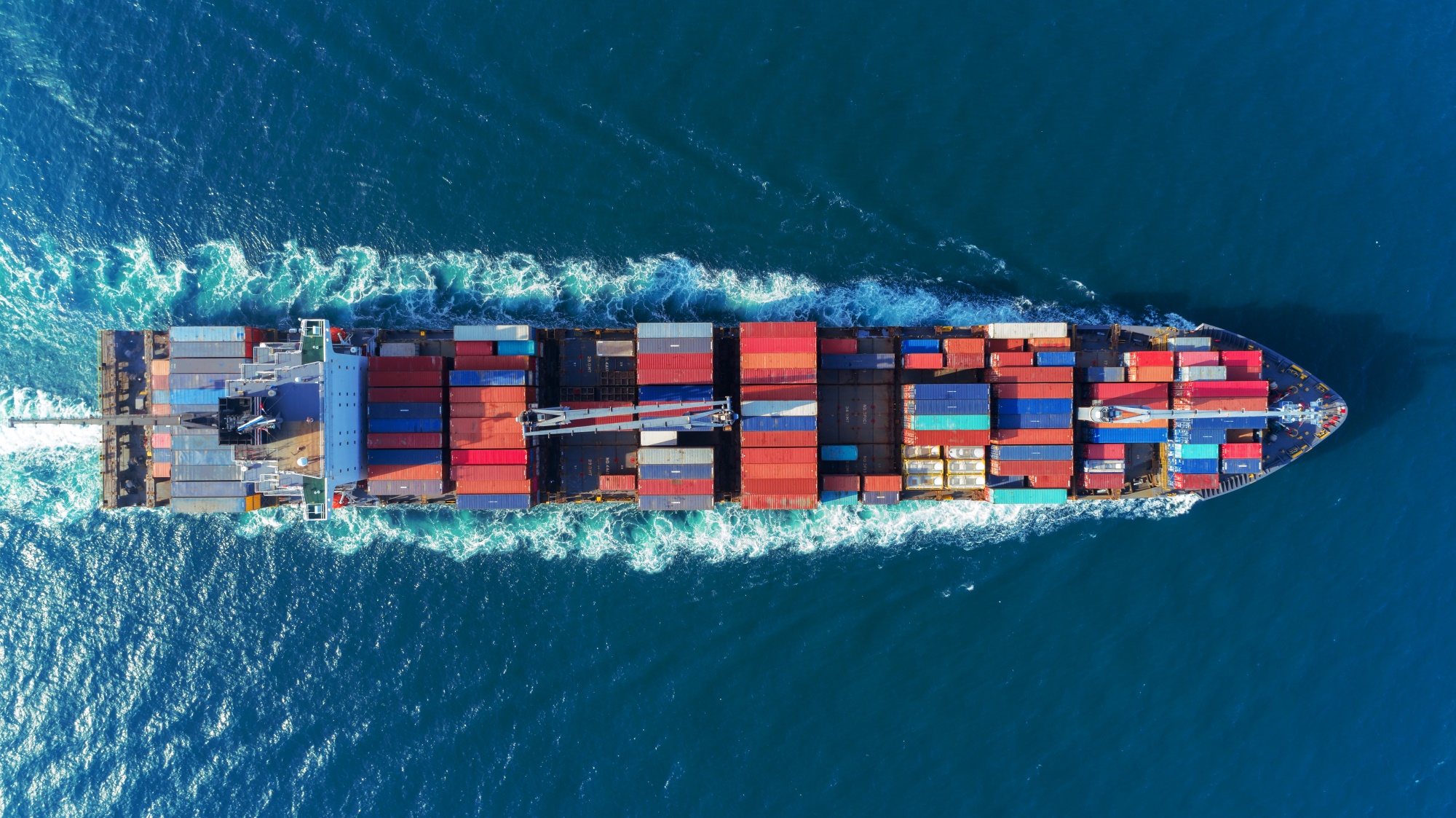 Aerial-view-Top-speed-with-beautiful-wave-of-container-ship-full-load-container-with-crane-load.jpeg